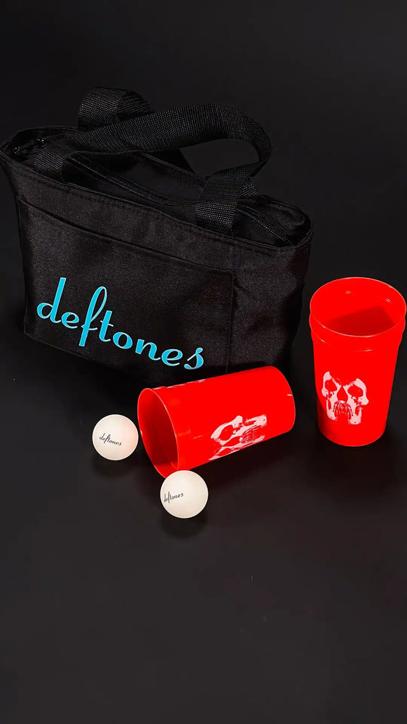 Deftones-branded beer pong set with two red cups and two white balls.